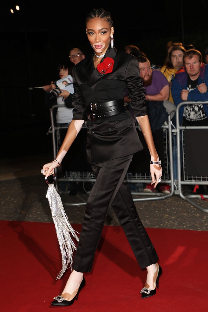 Winnie Harlow in a Prada fall 2019 menswear suit and Manolo Blahnik heels