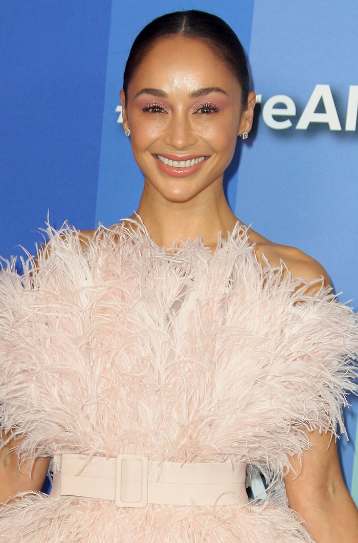 Cara Santana looks lovely in a Nicole + Felicia pink feathered dress