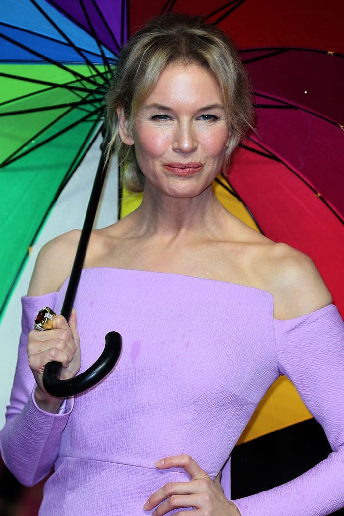 Renee Zellweger with a rainbow umbrella and a ruby ring