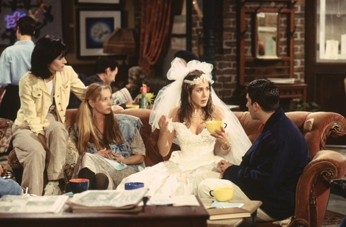 Courteney Cox (as Monica Geller), Lisa Kudrow (as Phoebe Buffay), Jennifer Aniston (as Rachel Green), and David Schwimmer (as Ross Geller) in the first episode of Friends titled "The Pilot" (also known as "The One Where It All Began", "The One Where Monica Gets A Roommate" and "The First One"), which premiered on September 22, 1994