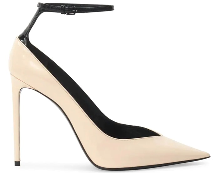 A slender black ankle strap perched on a creamy patent leather pump sets a fashion-forward tone, as does this style's notched pointy toe and setback stiletto