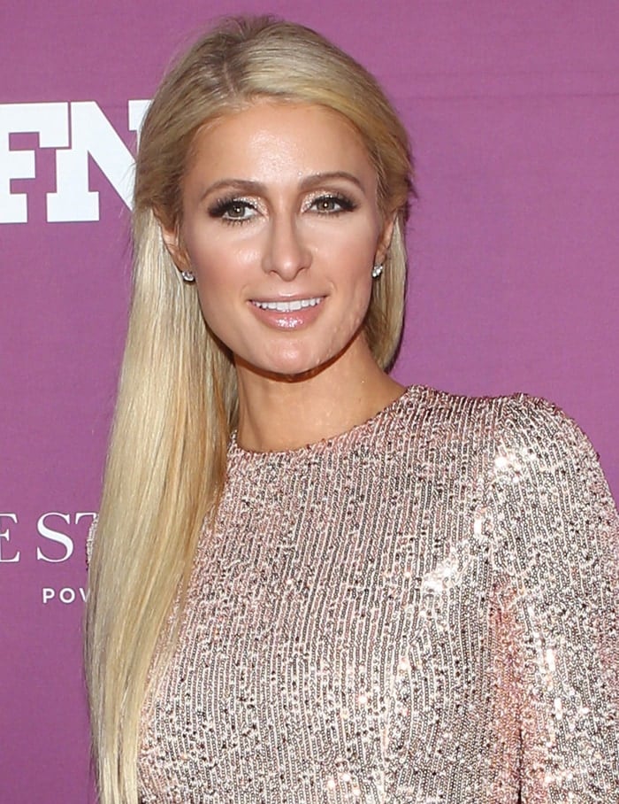 Paris Hilton styles her long blonde hair straight with glittery eyeshadow