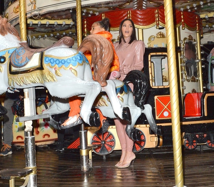 Kim Kardashian and North West are seen on a carousel at the Eiffel Tower