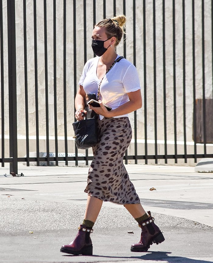 Hilary Duff teams a classic white tee with a leopard-print midi skirt