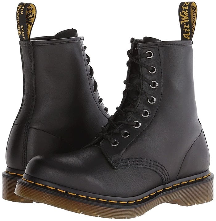 These women's 1460 boots from Dr. Martens feature visible yellow stitching, grooved sides, and a scripted heel-loop