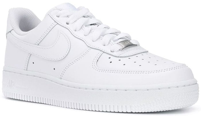 White leather blend Air Force One sneakers from Nike featuring a front lace-up detail, a ridged rubber sole, a logo patch at the tongue, perforated air holes, and logo to the side