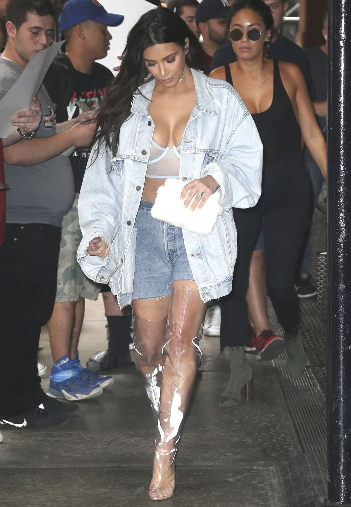 Kim Kardashian steps out in New York City on September 6, 2016, wearing a bleached Yeezy Season 5 jacket, PVC transparent Yeezy Season 4 boots, and a La Perla bra, with her fogged-up boots showcasing the perils of clear footwear