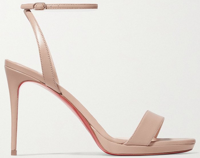 These elegant Loubi Queen 100 sandals by Christian Louboutin, in smooth leather with a slender stiletto heel, offer a sophisticated contrast to casual joggers
