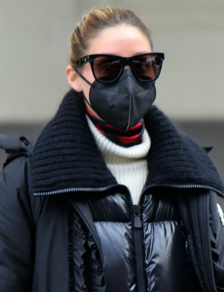 Olivia Palermo scrapes her hair back and accessorizes with tortoiseshell sunnies and black face mask