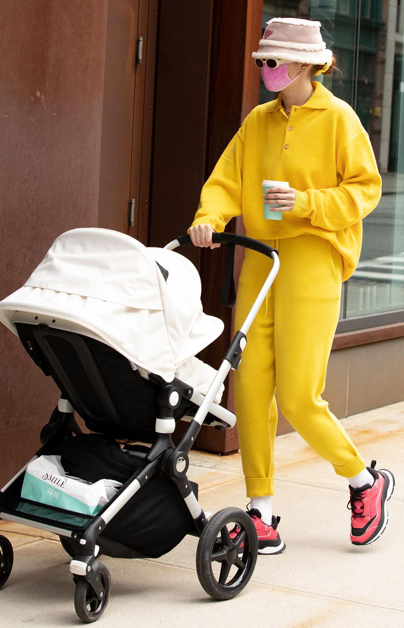 Gigi Hadid is ray of sunshine in Amiss Conception yellow polo sweater and joggers while out with daughter Khai in New York City on April 1, 2021