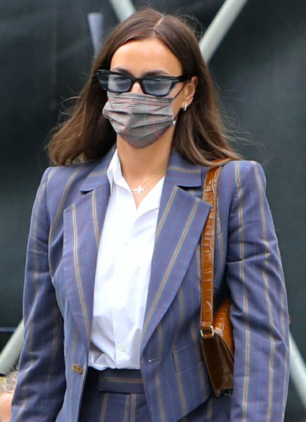 Irina Shayk hides her face in Fenty Inside Story sunnies and Maskc tartan face mask