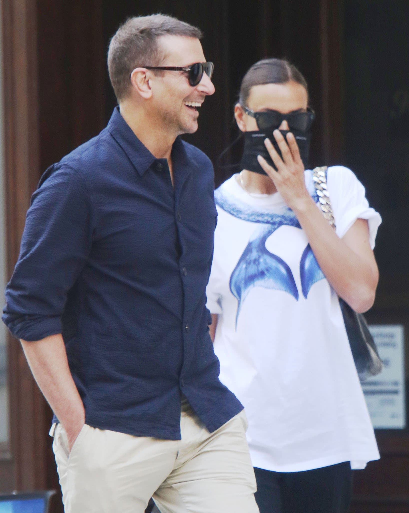 Irina Shayk wears a sleek bun and hides her face behind her Celine sunglasses and face mask