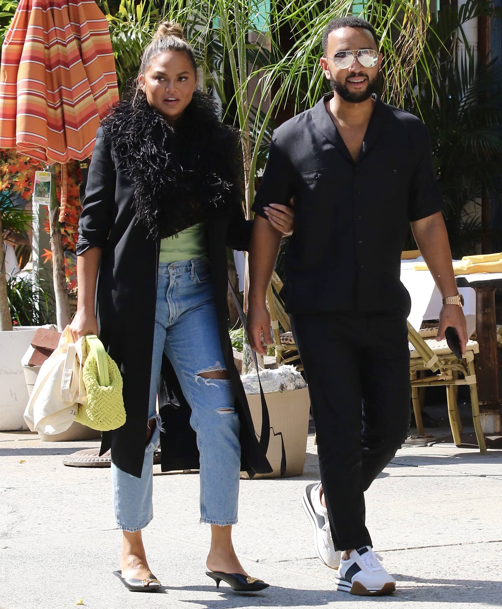 John Legend looks handsome in his black shirt, jeans, and Tom Ford James sneakers