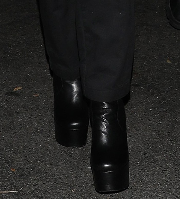 Nicola Peltz completes her all-black look with Yves Saint Laurent Billy platform boots