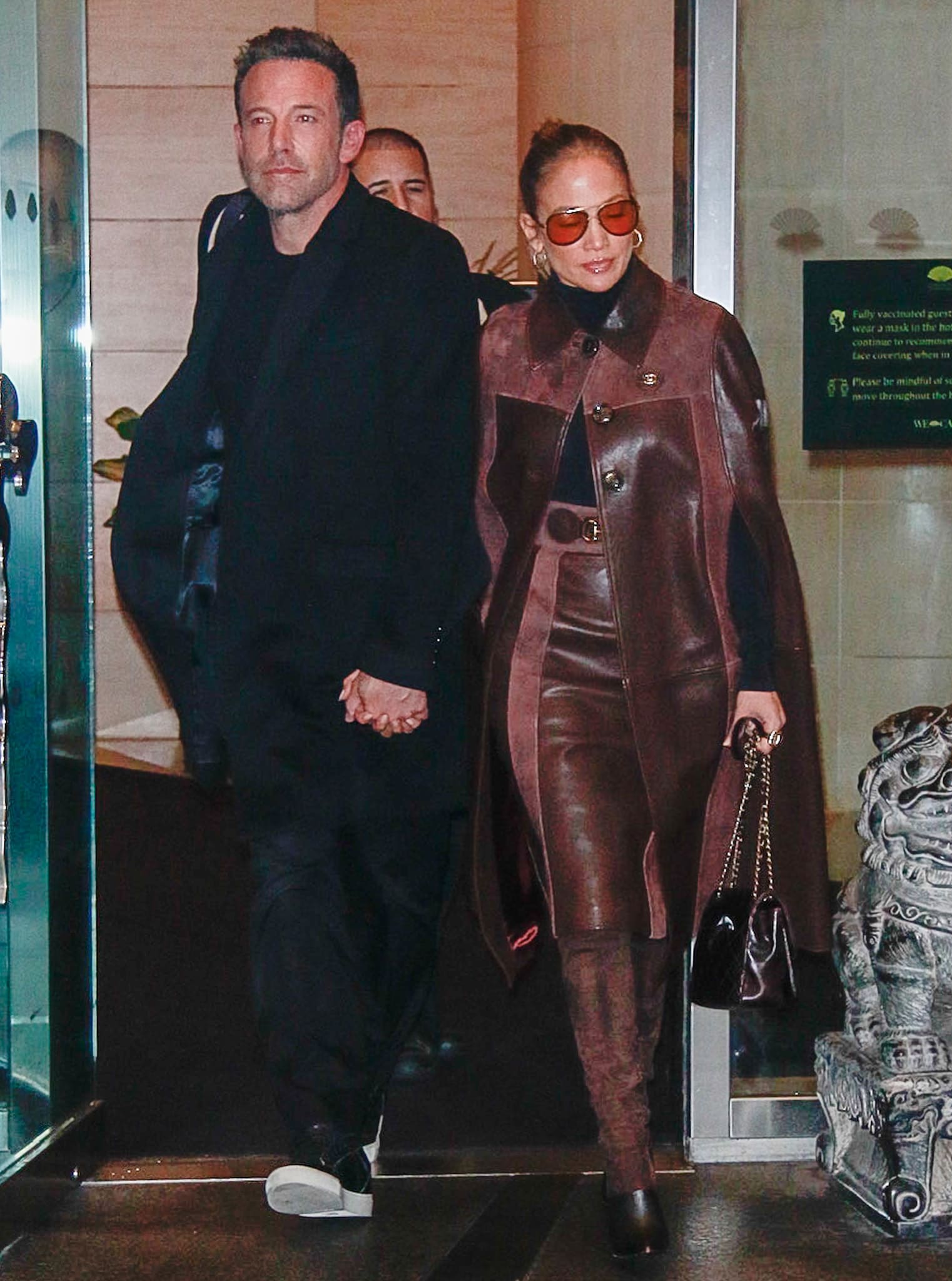 Ben Affleck and Jennifer Lopez holding hands while leaving the Mandarin Hotel in New York City on October 10, 2021