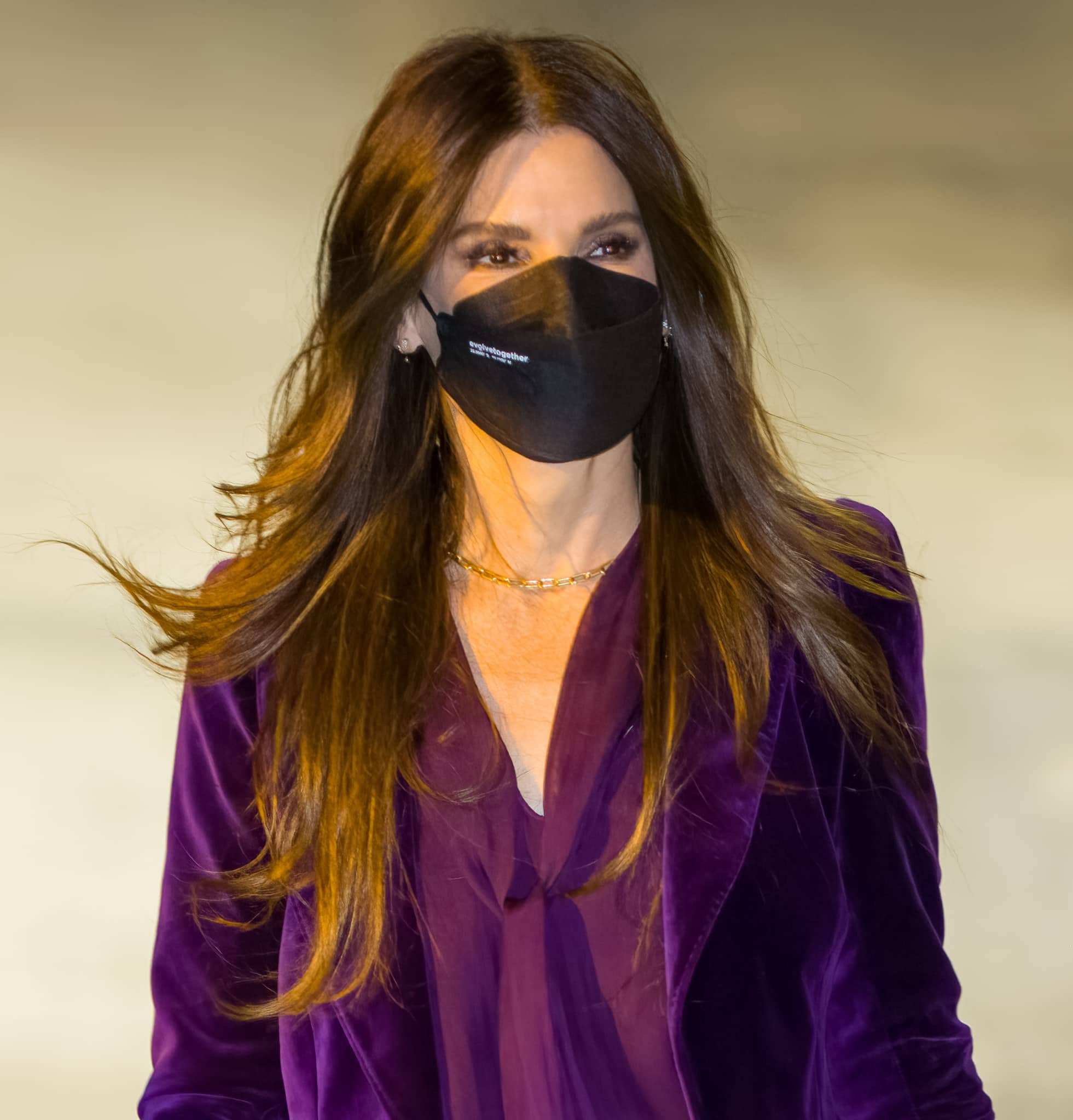 Sandra Bullock wears her long caramel tresses down, framing her minimally made-up face