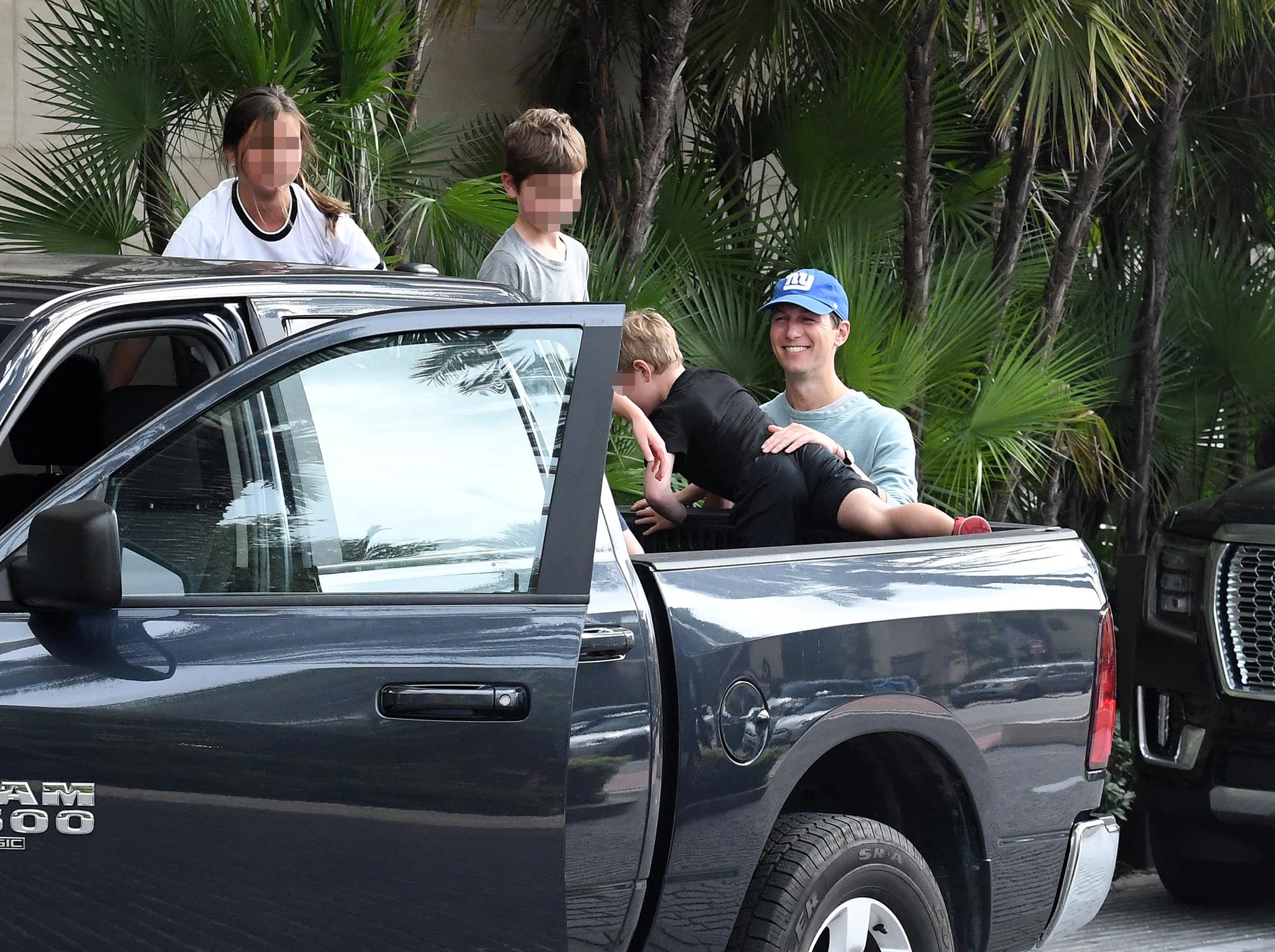 Jared loads his kids in the back of the pickup truck but changes his mind after seeing the photographers