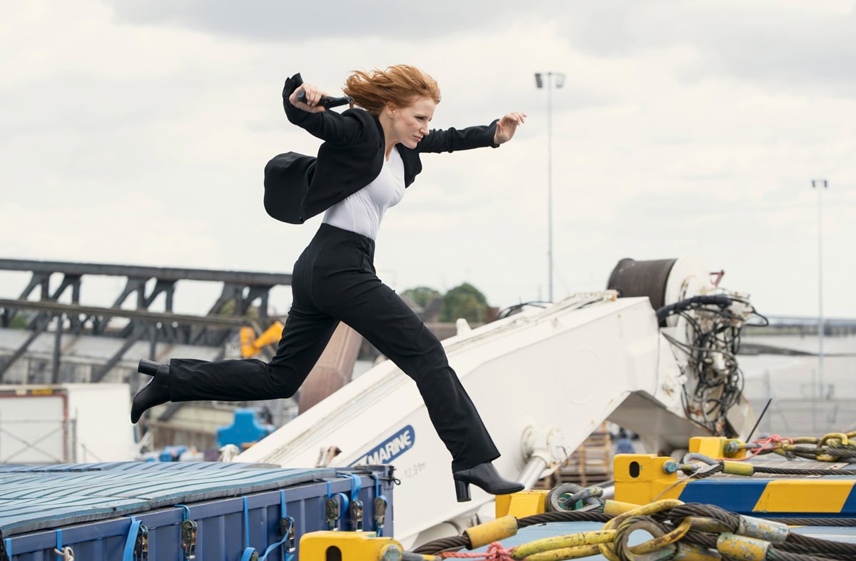 Jessica Chastain, as Mason "Mace" Brown, performs an intense stunt in sleek black high heels, proving that espionage and elegance go hand in hand