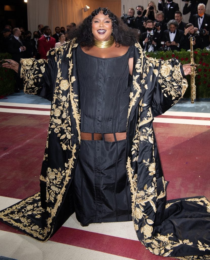 Lizzo Plays Gold John Lunn Flute on Met Red Carpet