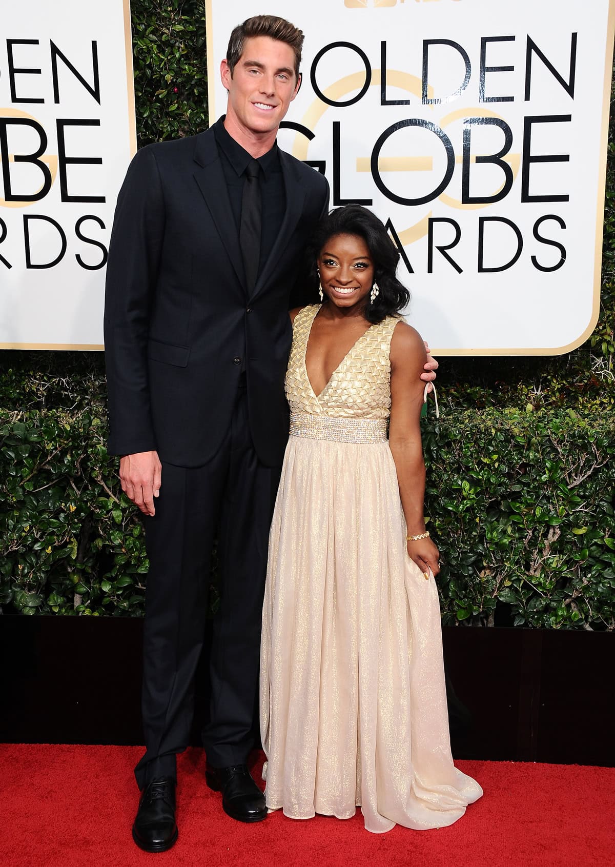 In this striking photo, Simone Biles, at a petite 4'8" (142.2 cm), looks like a pocket-sized powerhouse next to the towering Conor Dwyer, who stands at a lofty 6'5" (196 cm)