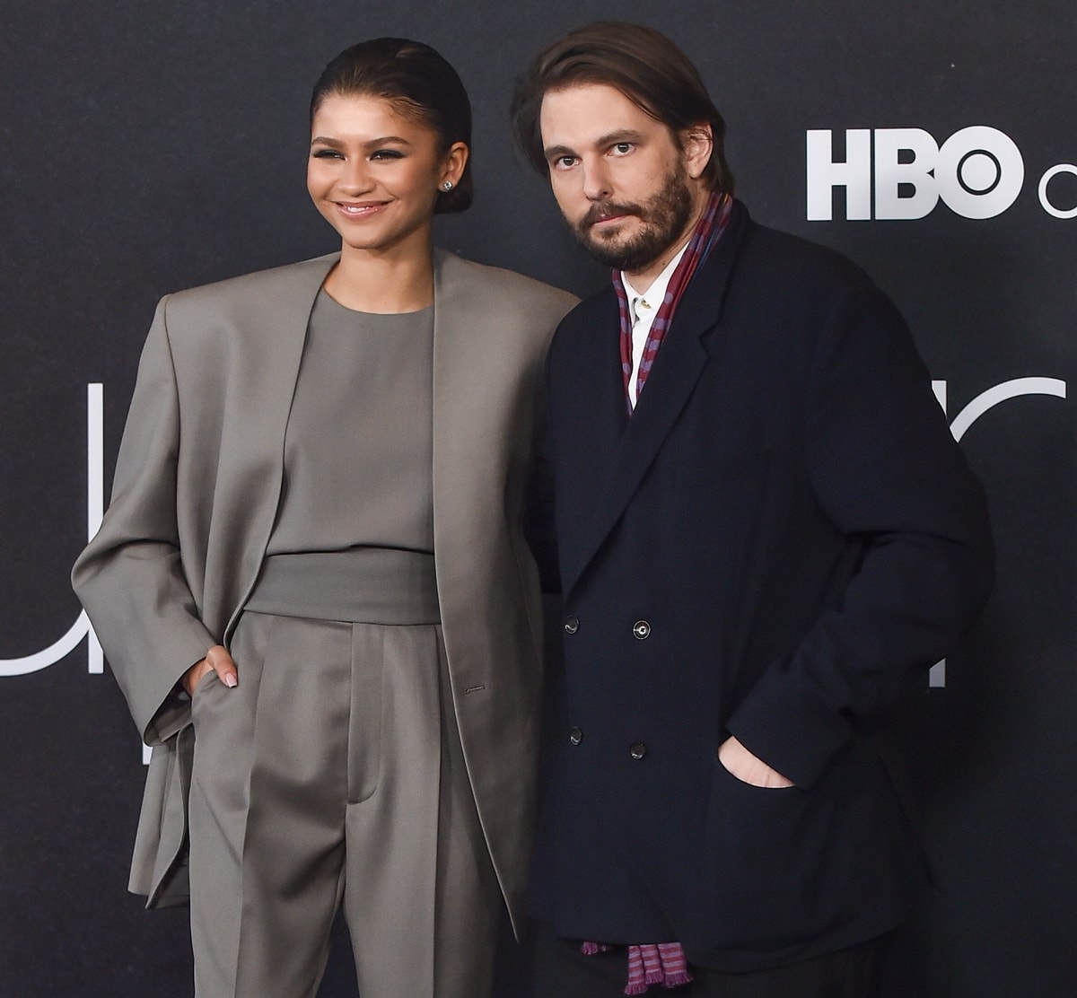 Zendaya in a gray Fear of God suit and Sam Levinson attend the HBO Max FYC event for "Euphoria"