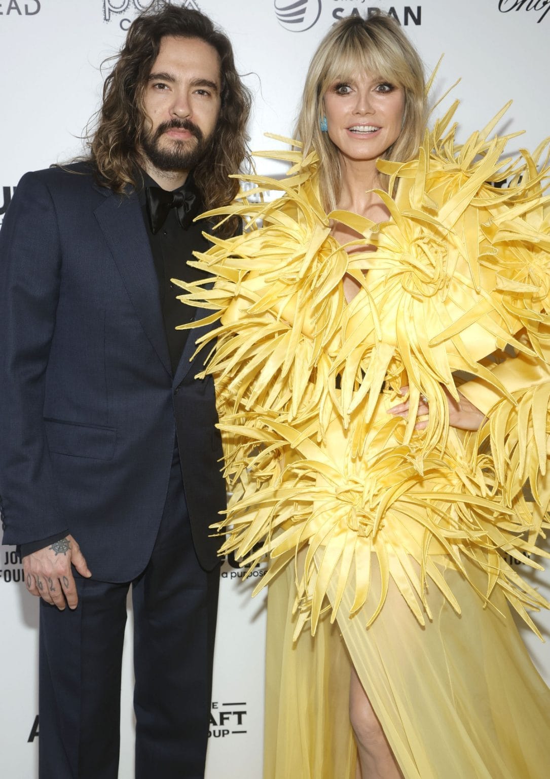 Heidi Klum Makes Grand Entrance in Yellow Feathered Dress at Elton John ...