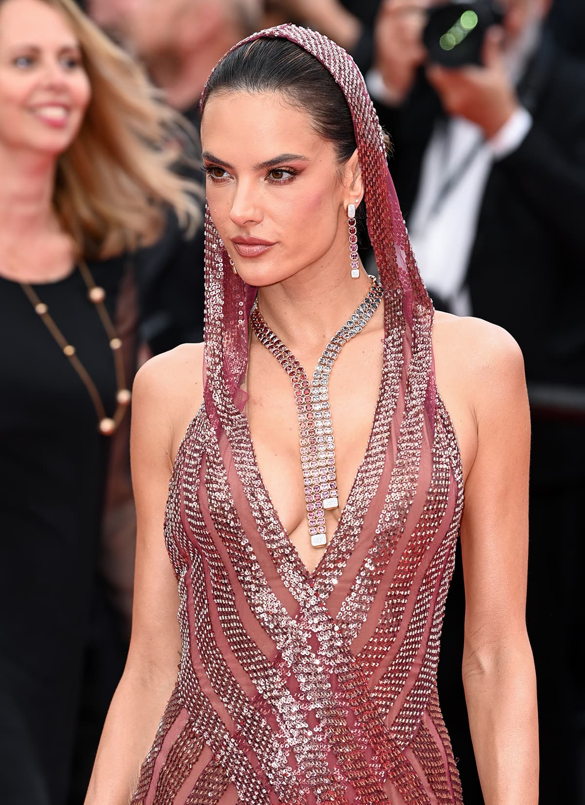 Alessandra Ambrosio complements her burgundy gown with a Pomellato necklace and earrings and a red smokey eyeshadow