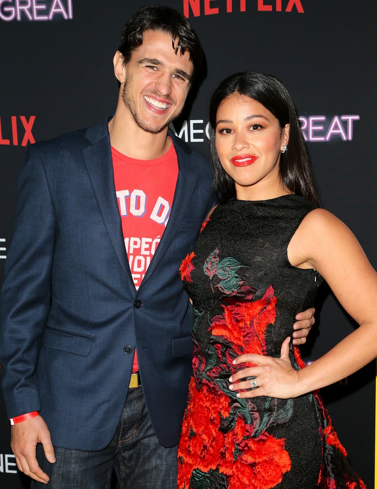 Joe LoCicero and Gina Rodriguez posing for photographs together at the screening of Someone Great