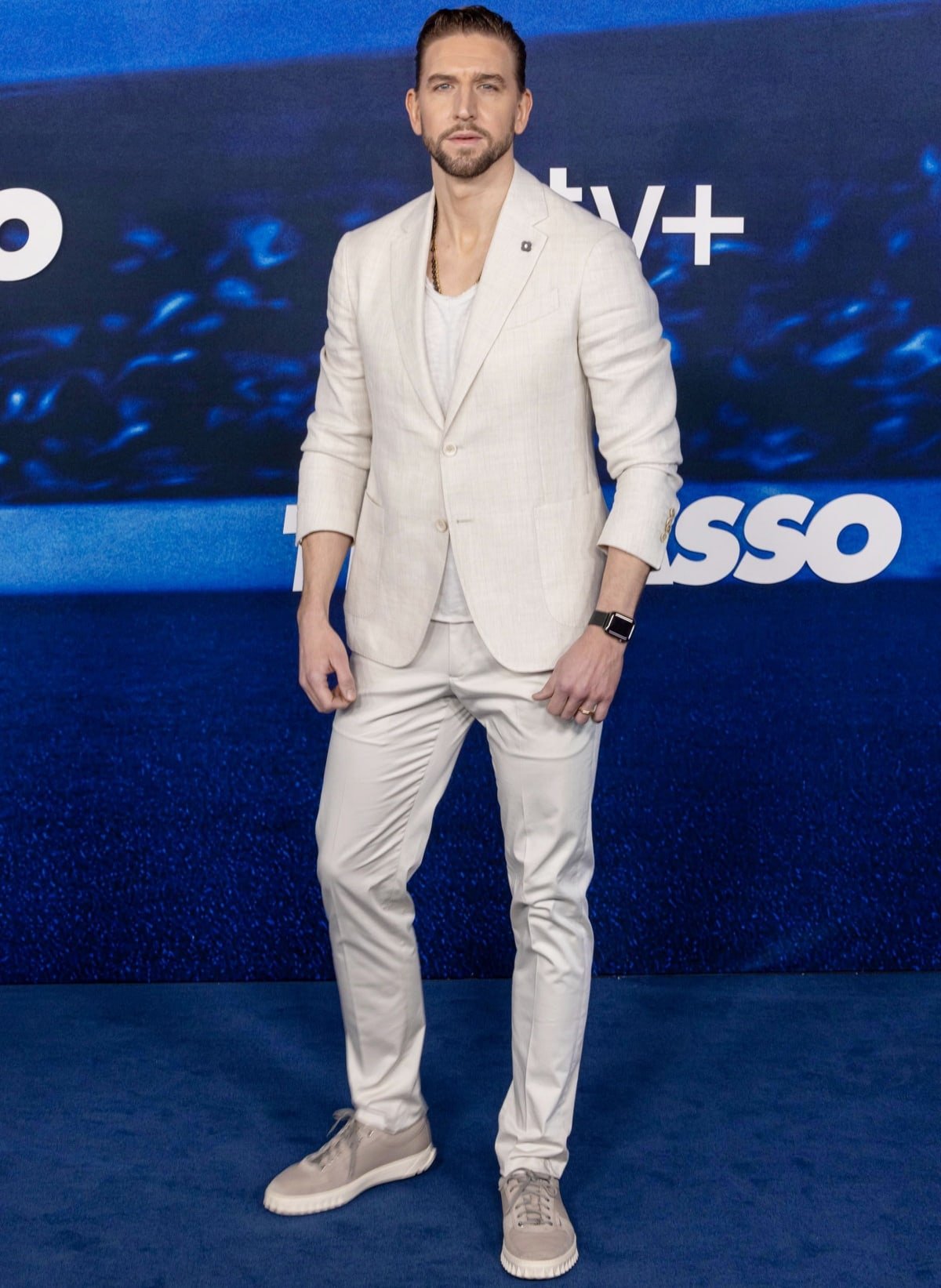 Maximilian Osinski in a cream-colored suit at the season 3 premiere of Ted Lasso