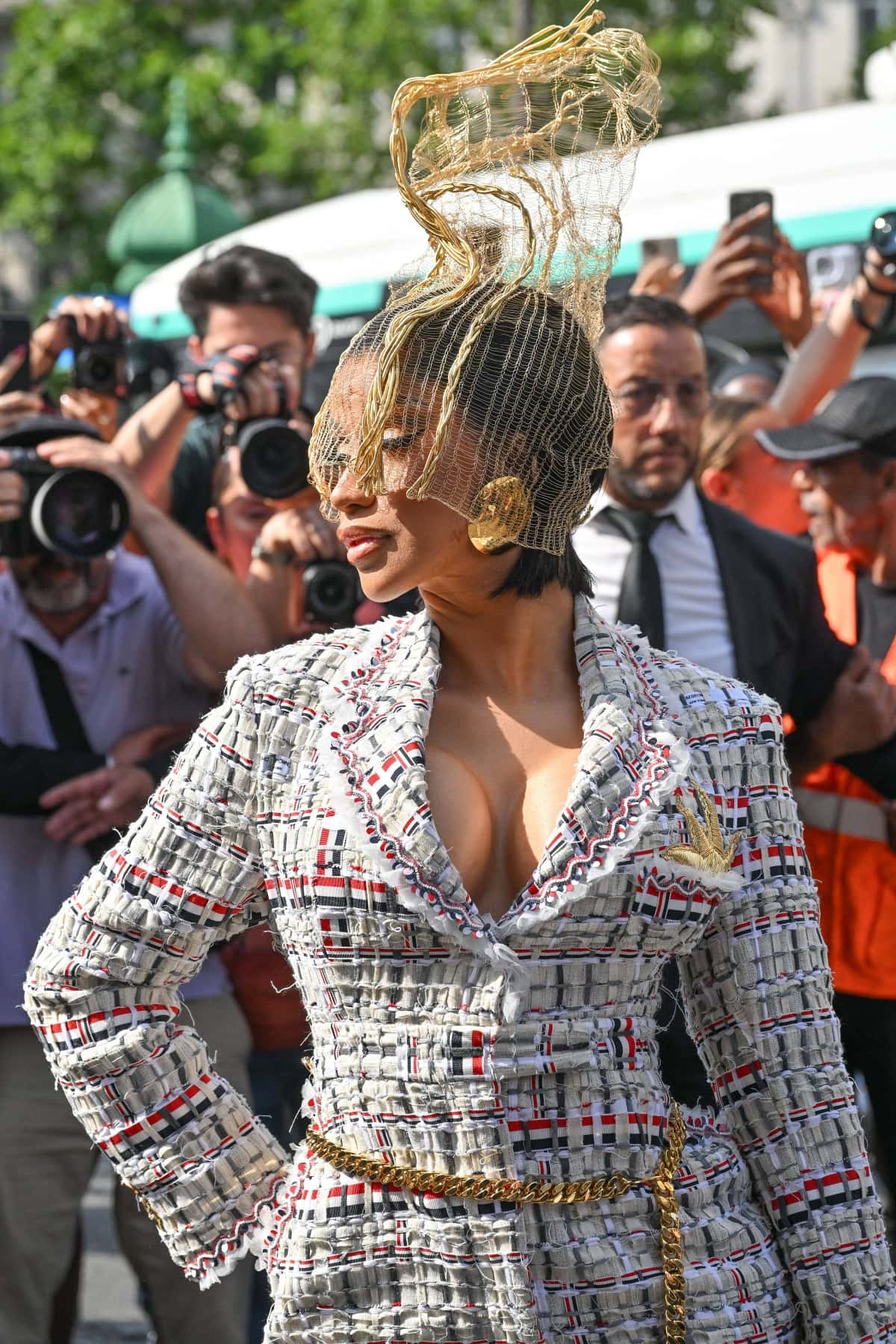 Cardi B amped up the drama with a gold wire headpiece covering half of her face