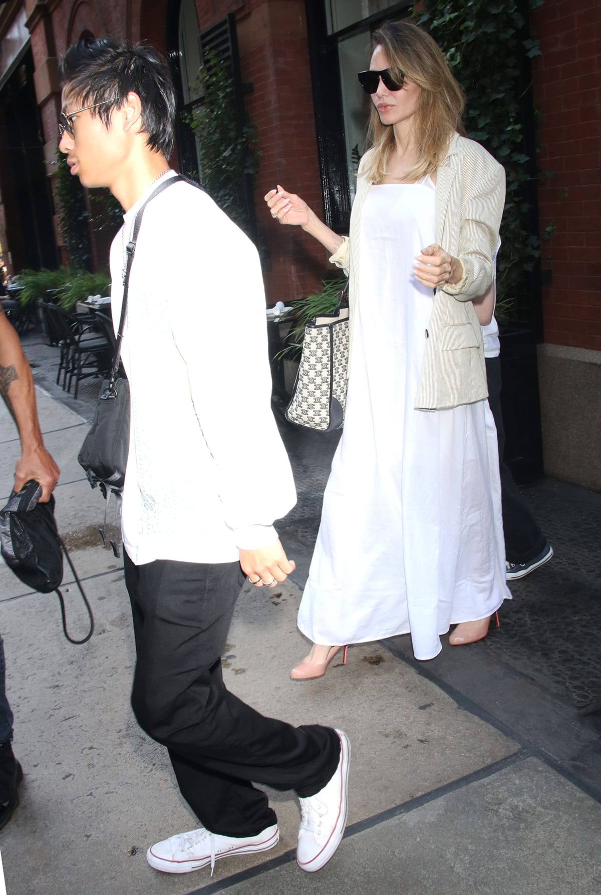 Angelina Jolie serves major summer vibes in a white maxi dress while out with kids, Pax and Vivienne, in New York City on August 18, 2023