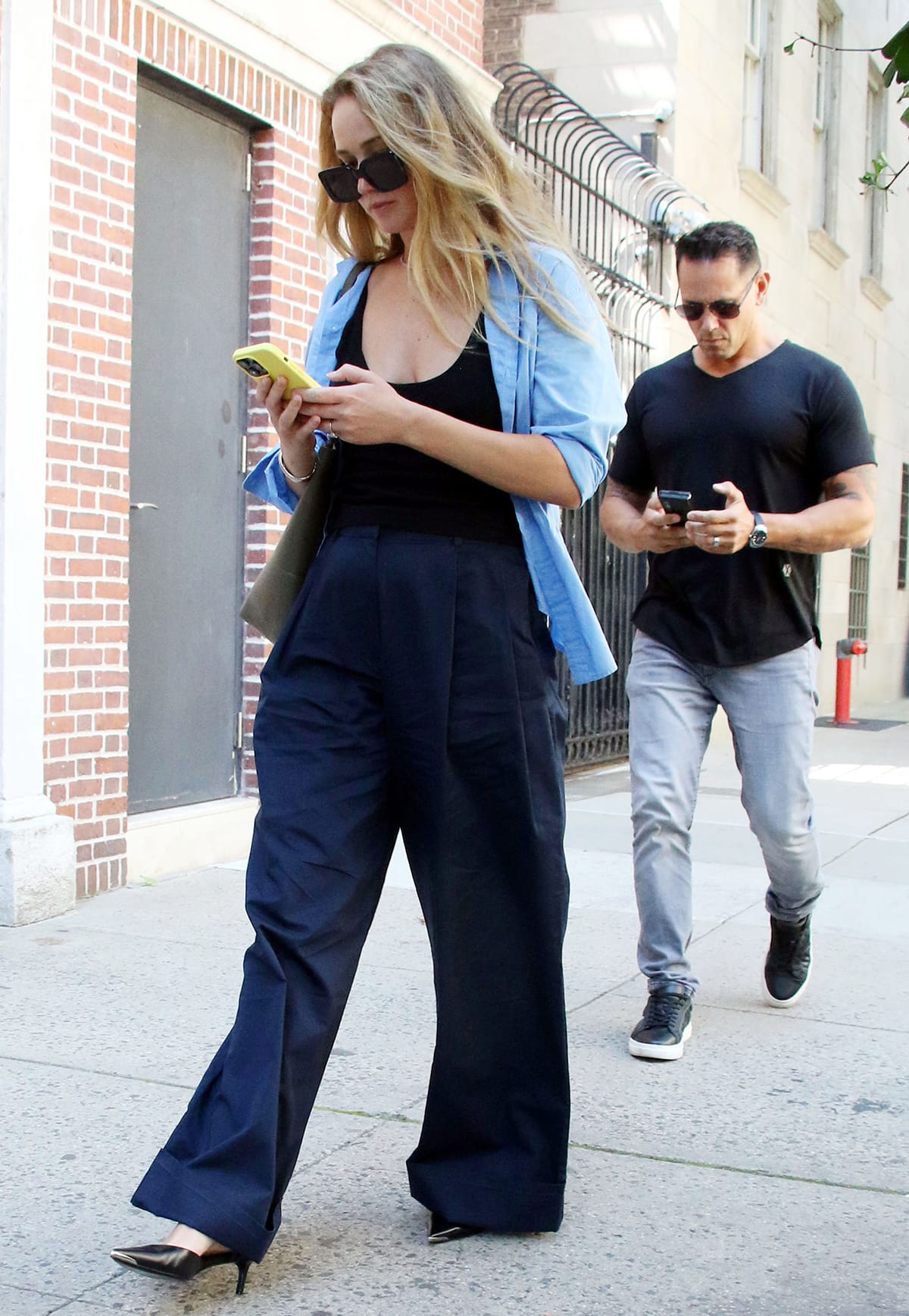 Jennifer Lawrence debunks old fashion myth and pairs her black tank top with navy pants while strolling around New York City on August 23, 2023