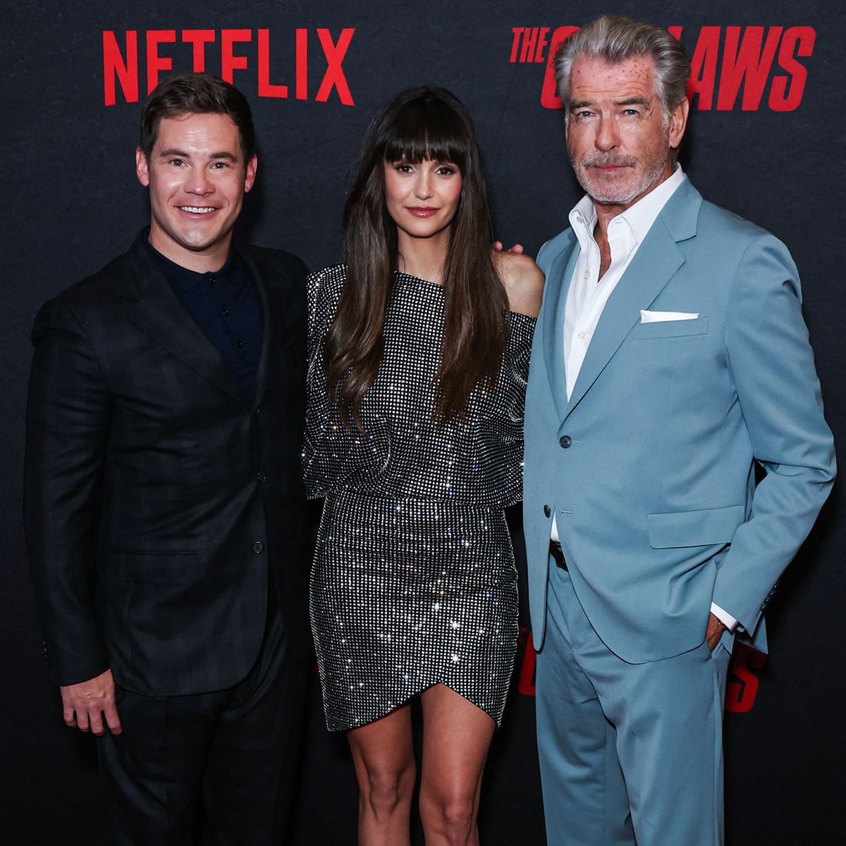 Pierce Brosnan stands at 6 feet ¾ inch (184.8 cm), while Adam DeVine is 5 feet 6 ¾ inches (169.5 cm) tall, and Nina Dobrev's height is 5 feet 5 ¼ inches (165.7 cm), making a noticeable difference in their heights