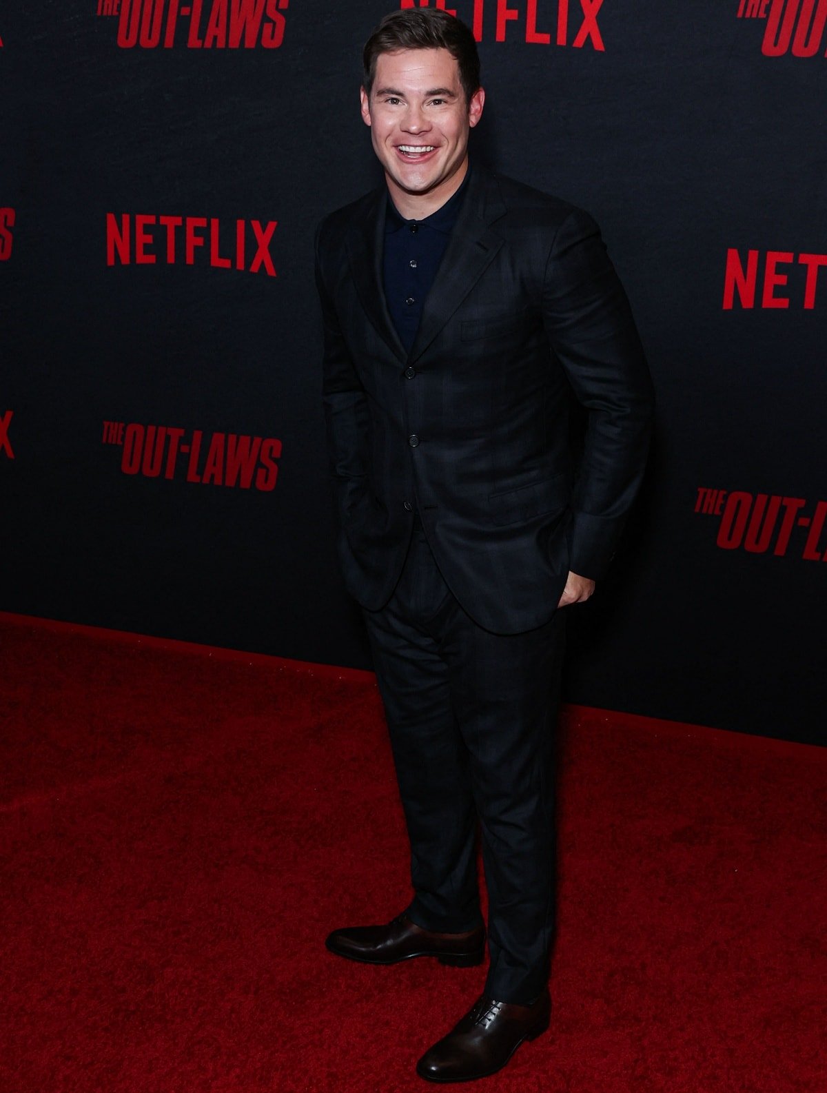 Adam DeVine in a dark ensemble at the Los Angeles premiere of The Out-Laws