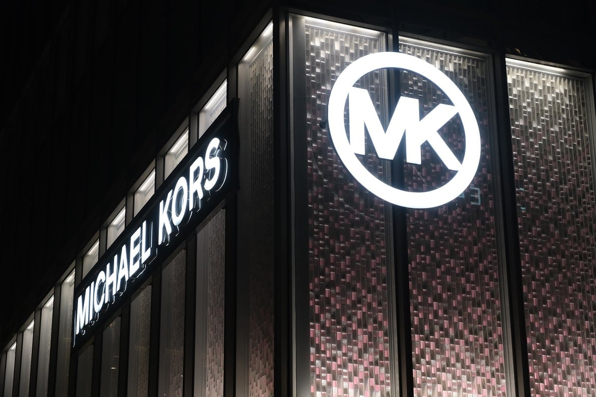 The two logos typically used by Michael Kors are the expanded logo and the circle emblem