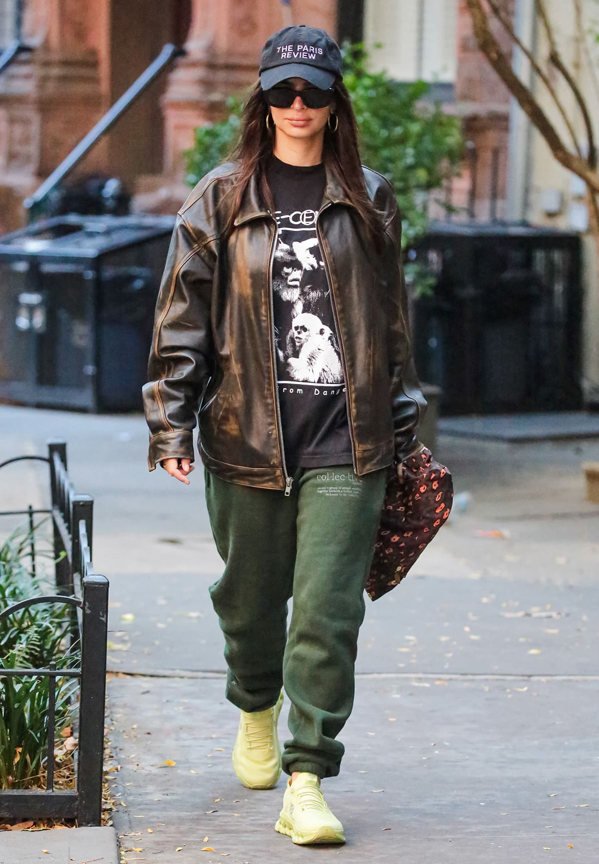 Emily Ratajkowski looks cool in a grungy but chic Mimchik brown leather jacket, black Online Ceramics tee, and green Helfrich Collective sweatpants on October 11, 2023