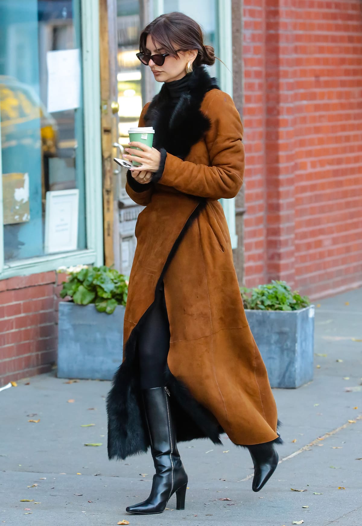 Emily Ratajkowski's coat is made of rich cognac suede with plush black Toscana shearling lining and trims