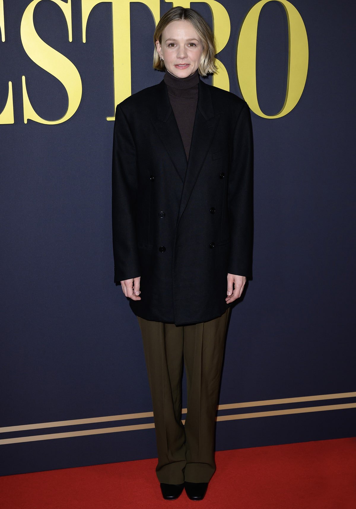 Carey Mulligan fails to impress in a brown turtleneck top, matching loose-fitting pants, and an oversized black blazer