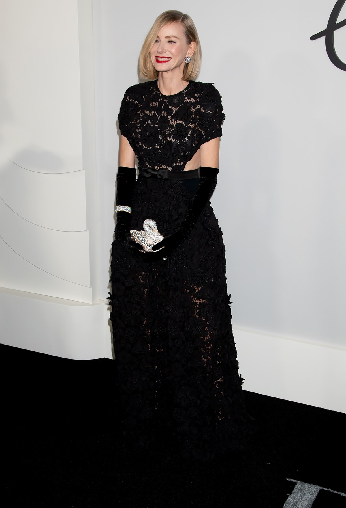Just like her Feud character, Babe Paley, Naomi Watts leads the glamour in a black floral lace gown from Givenchy's Spring 2019 collection at the NYC premiere of Feud: Capote vs. The Swans on January 23, 2024