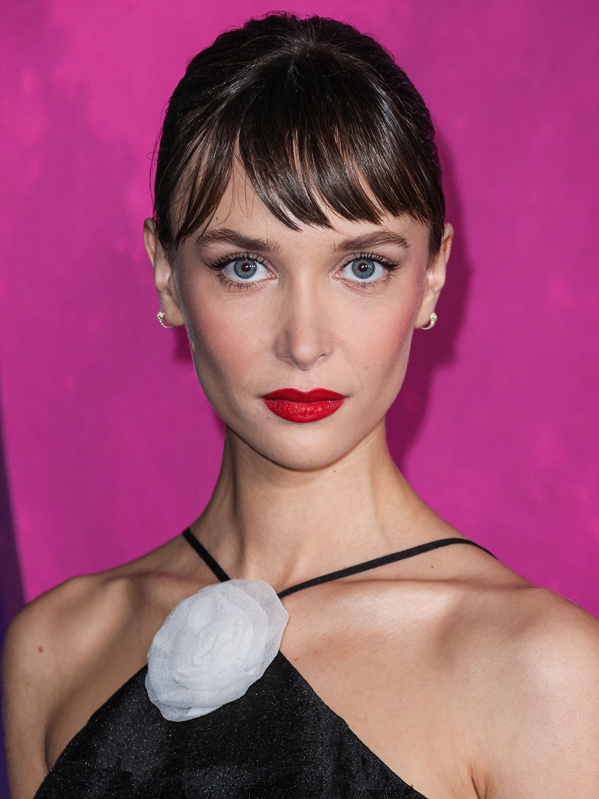 Ari Fournier wears Audrey Hepburn bangs with mascara and bold red lipstick