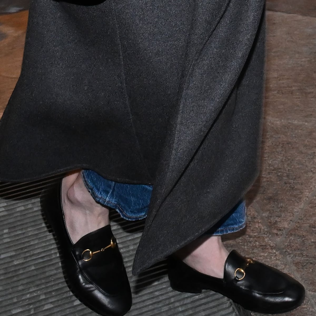 Kirsten Dunst wears black Gucci Jordaan loafers featuring the iconic Horsebit detail