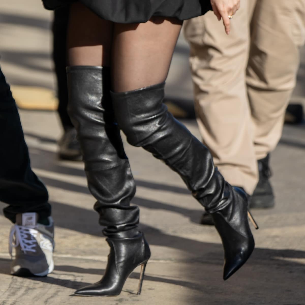 Selena Gomez elevates her chic, all-black Parisian ensemble with a pair of sleek Stuart Weitzman Ultrastuart stretch boots