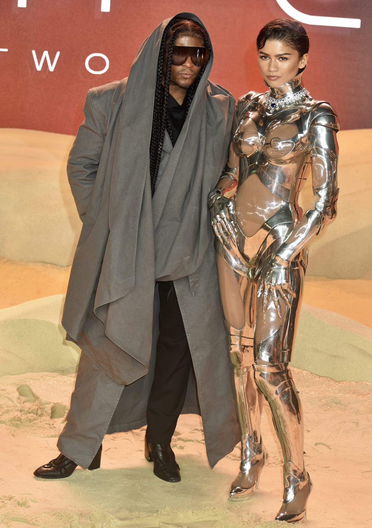 Zendaya, in her striking metallic robot suit from Thierry Mugler's 1995 couture collection, poses alongside her visionary stylist, Law Roach, at the world premiere of 'Dune: Part Two'