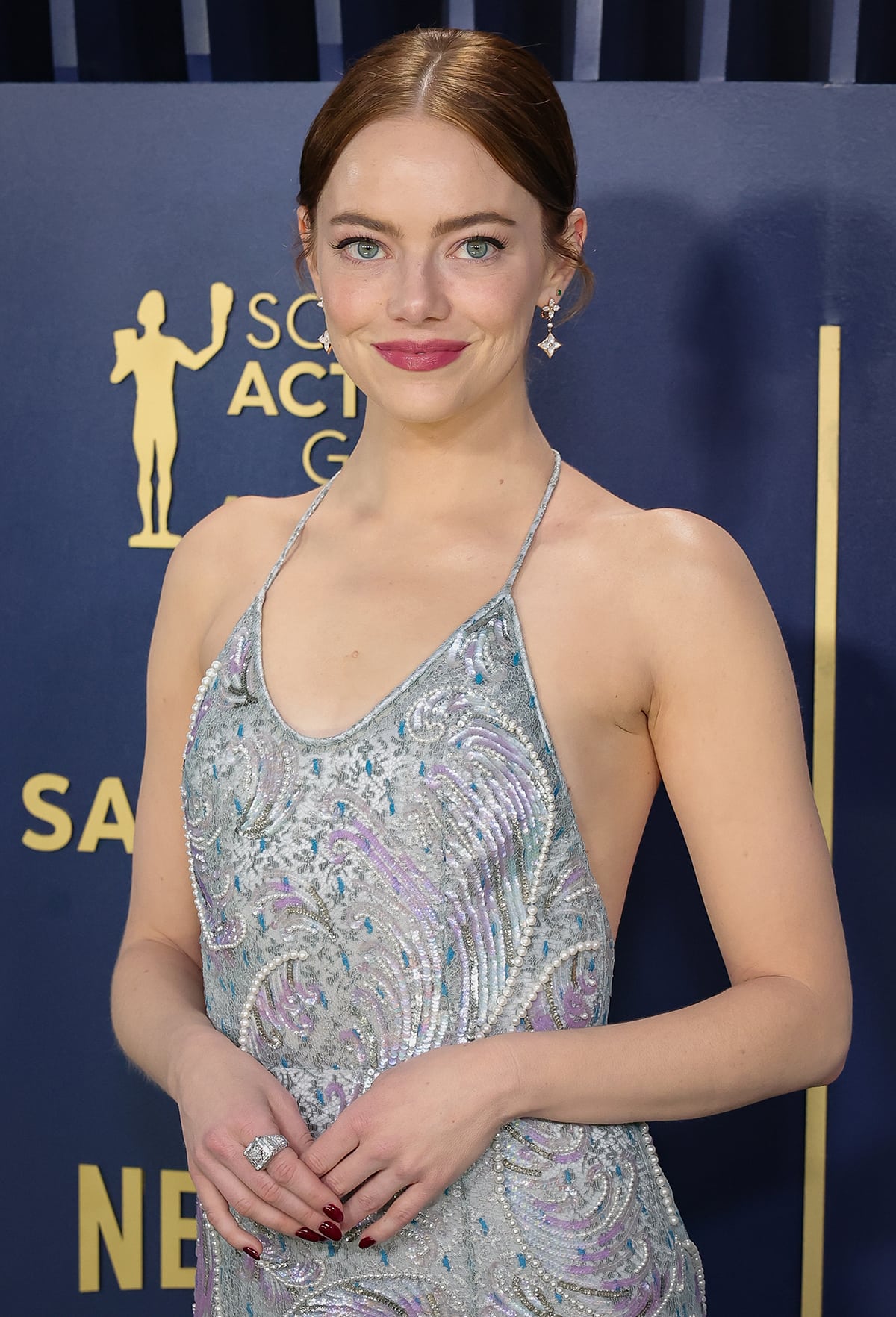 Emma Stone lets her gown do the talking and pulls her red hair up into a simple bun