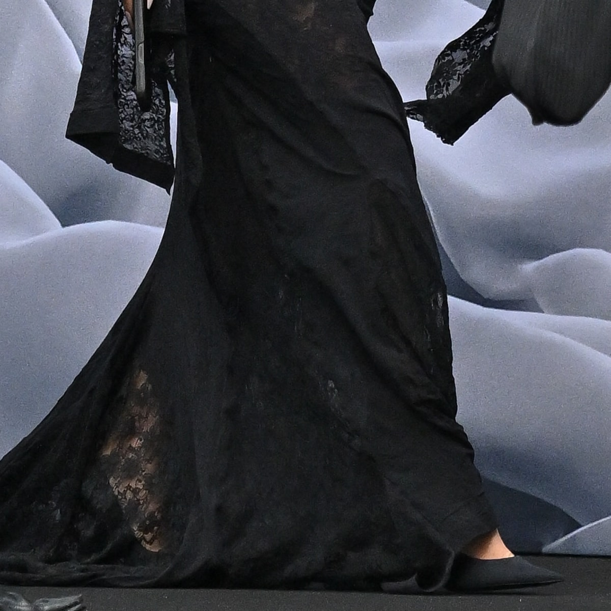 Underneath her dramatic gown, Kim Kardashian paired her look with elegant black high-heeled pumps, adding a classic touch to her avant-garde ensemble