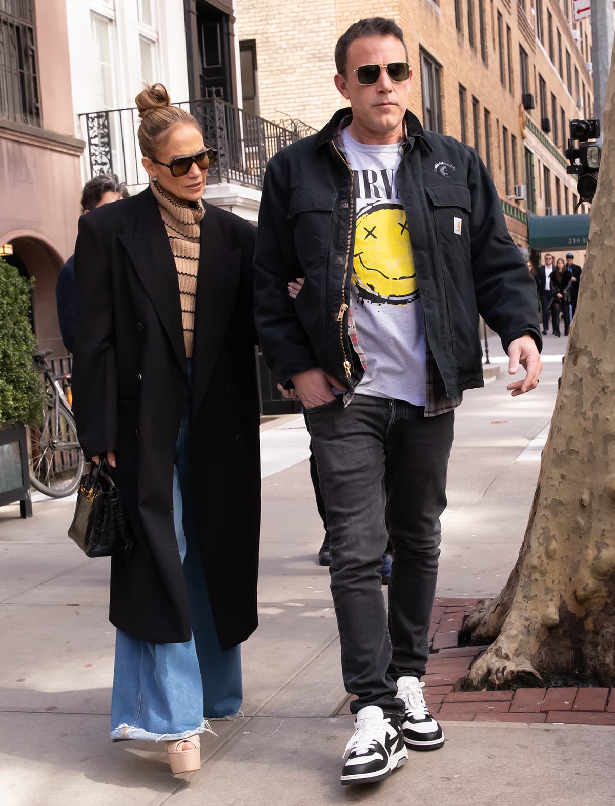 Jennifer Lopez opts for towering platform heels while Ben Affleck keeps it comfy in black-and-white shoes for their house-hunting trip