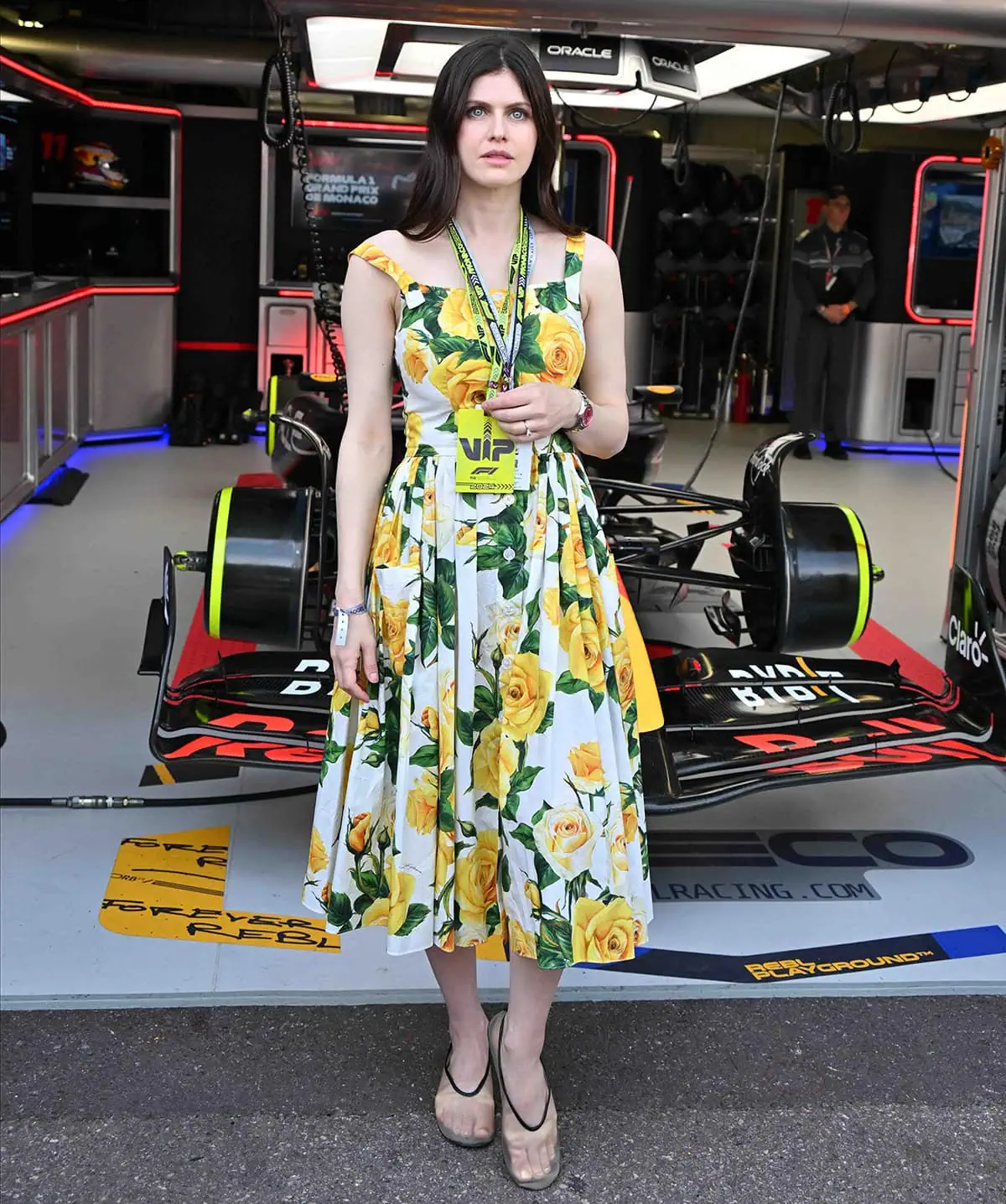 Alexandra Daddario's Dolce & Gabbana floral dress features front buttons and a pleated midi skirt, making it a perfect summertime dress