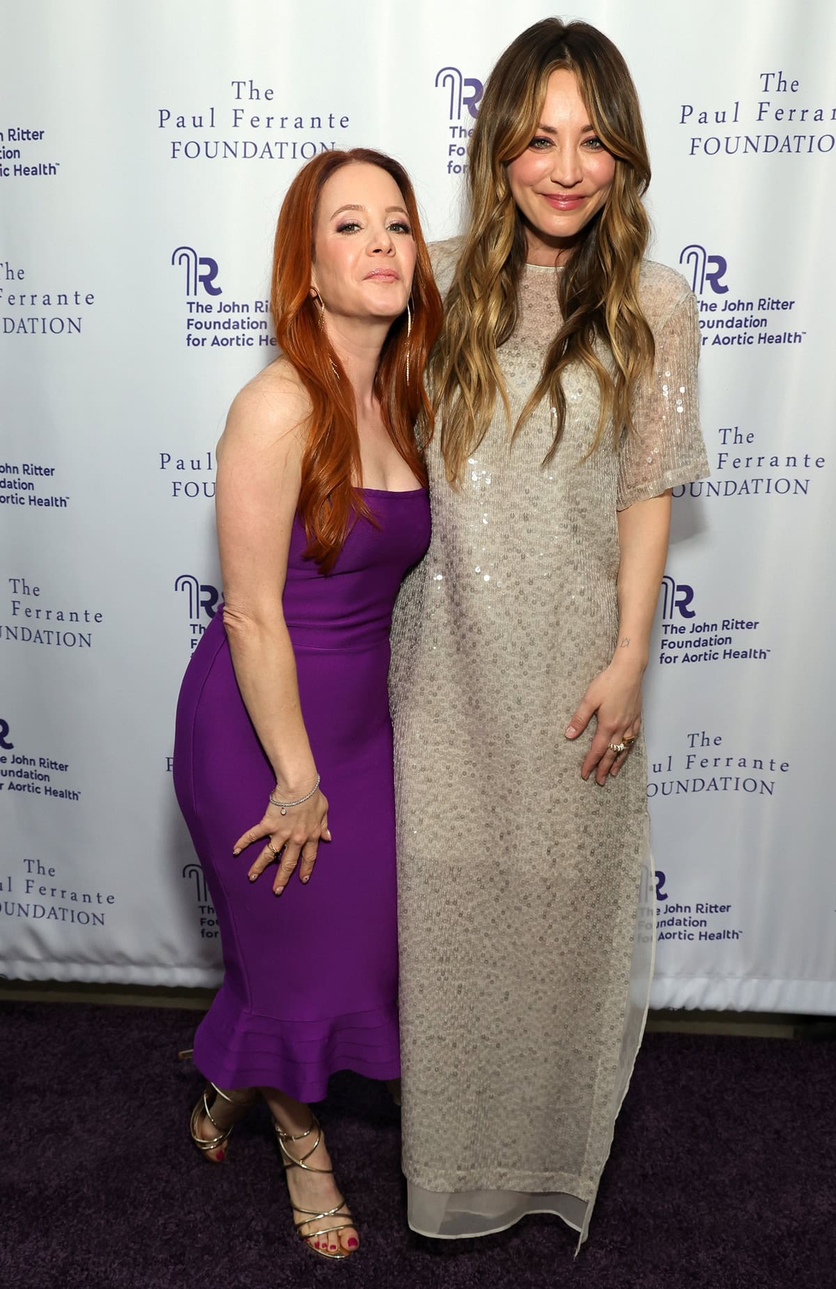 Kaley Cuoco and Amy Davidson's height difference is noticeable as they pose together on the red carpet at the 2024 Evening From the Heart Gala