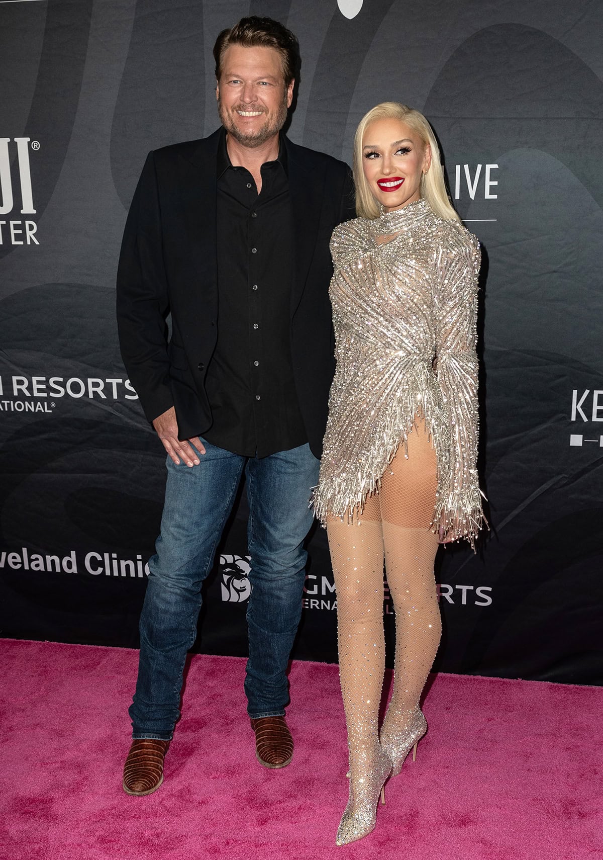 Gwen Stefani dazzles in a heavily embellished see-through mini-dress by Albina Dyla with crystal bead fringes along the asymmetrical hem