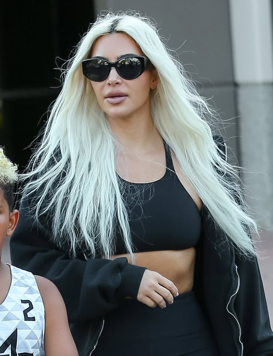 Kim Kardashian looks makeup-free for the outing, with her long, platinum hair fashioned in casual waves